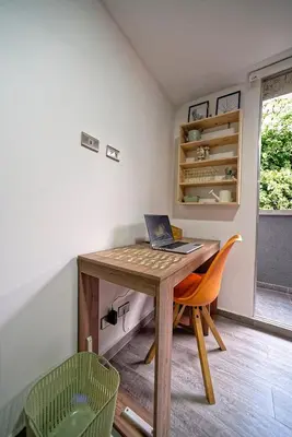 a room with a desk with a laptop on it at Diseño único y encanto en un barrio tranquilo, in Medellín