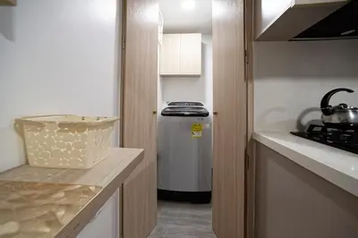 a small kitchen with a stove and a refrigerator at Diseño único y encanto en un barrio tranquilo, in Medellín