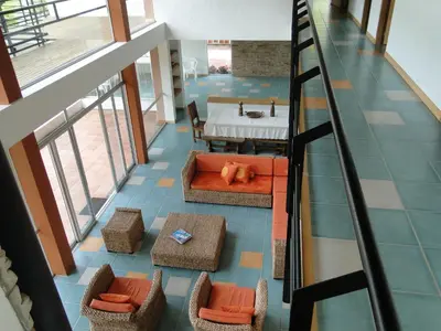 an overhead view of a living room with a table and chairs at Hotel Familiar El Remanso Del Agua in Guatapé