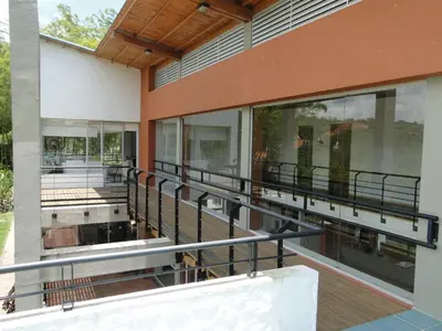 a view of the outside of a building with large windows at Hotel Familiar El Remanso Del Agua in Guatapé