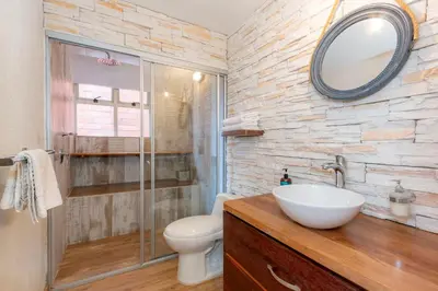 a bathroom with a sink and a toilet and a mirror at Edificio Casa Roma by Host Medellin in Medellín