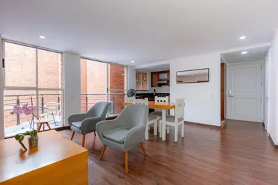 a living room with a dining room table and chairs at Edificio Casa Roma by Host Medellin in Medellín