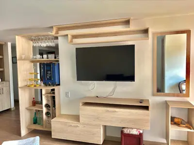 a living room with a flat screen tv on a wall at Apartamento con amplia zona de trabajo in Rionegro