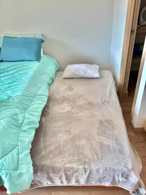 a unmade bed with a pillow on top of it at Apartamento con amplia zona de trabajo in Rionegro