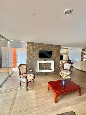a living room with two chairs and a fireplace at Apartamento con amplia zona de trabajo in Rionegro