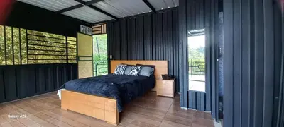 a bedroom with a bed and a balcony at Cabañas Ecologe BLESS in Chiquinquirá