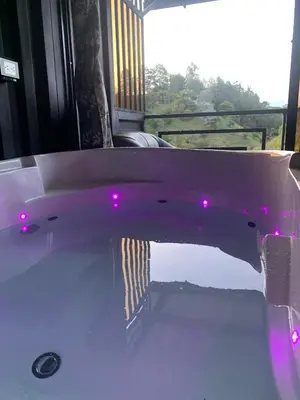 a bath tub with pink lights in a room at Cabañas Ecologe BLESS in Chiquinquirá