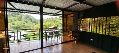 a room with a balcony with a view of a mountain at Cabañas Ecologe BLESS in Chiquinquirá