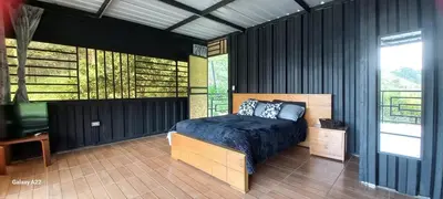 a bedroom with a bed and a television in it at Cabañas Ecologe BLESS in Chiquinquirá
