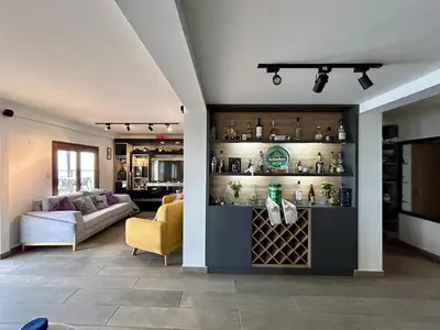 a living room with a shelf with wine bottles at LP Finca la Pergola, Naturaleza con Lujo y una increíble vista a todo Medellín in Medellín
