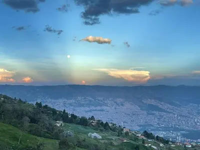a rainbow in the sky over a city at LP Finca la Pergola, Naturaleza con Lujo y una increíble vista a todo Medellín in Medellín