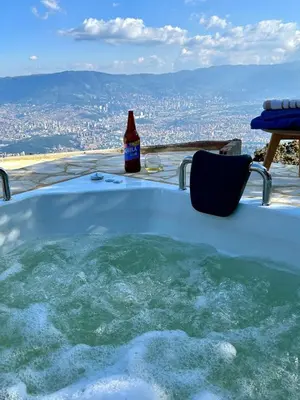 a bottle of beer sitting on top of a hot tub at LP Finca la Pergola, Naturaleza con Lujo y una increíble vista a todo Medellín in Medellín