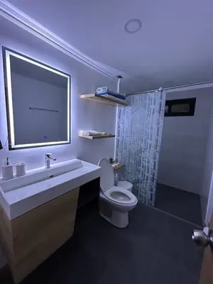 a bathroom with a toilet and a sink and a shower at LP Finca la Pergola, Naturaleza con Lujo y una increíble vista a todo Medellín in Medellín