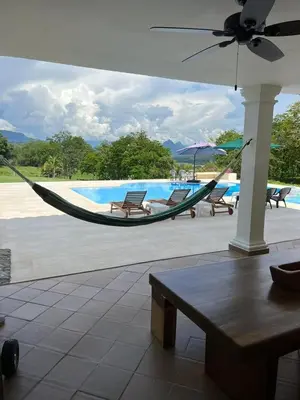 a hammock by a pool with chairs and a table at Disponible 4 enero 2026 hasta reyes-PASEOS GRANDES!!!-14 PAX-Hacienda Manantiales Paraíso Natural in Fredonia