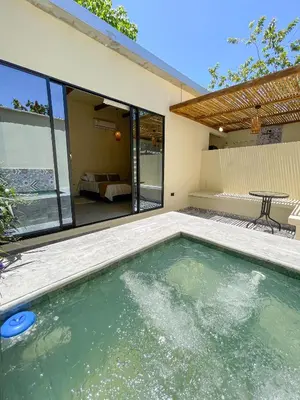 a swimming pool in the backyard of a house at Cabaña Privada con Jacuzzi en la Hacienda Nápoles in Doradal