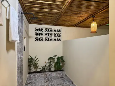 a hallway with a wooden ceiling and a rug at Cabaña Privada con Jacuzzi en la Hacienda Nápoles in Doradal