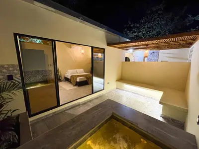 a room with a pool in the middle of a house at Cabaña Privada con Jacuzzi en la Hacienda Nápoles in Doradal