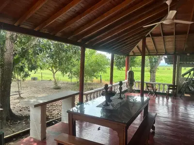 a porch with a table with figurines on it at Finca Hotel Ganadera La Bonita in Cantimplora