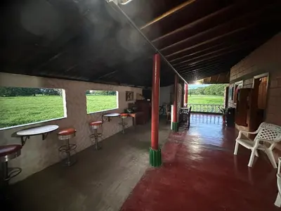 a room with tables and stools in a building at Finca Hotel Ganadera La Bonita in Cantimplora