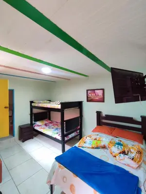 a bedroom with two bunk beds and a flat screen tv at DESCANSO DEL ARRIERO - Su Mejor Descanso en Guatapé in Guatapé