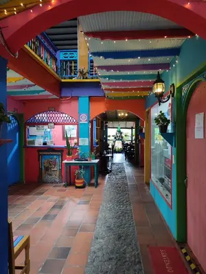 a restaurant with colorful walls and a hallway at DESCANSO DEL ARRIERO - Su Mejor Descanso en Guatapé in Guatapé
