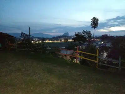 a fence on a hill with a view of a city at DESCANSO DEL ARRIERO - Su Mejor Descanso en Guatapé in Guatapé