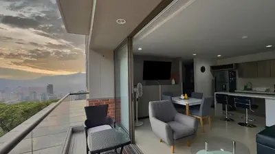a kitchen and living room with a view of the city at 3BR AC Top Location Views El Poblado in Medellín