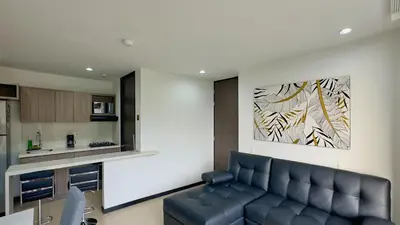 a living room with a couch and a painting on the wall at 3BR AC Top Location Views El Poblado in Medellín