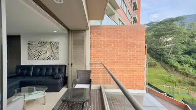 a balcony with a couch and a glass table at 3BR AC Top Location Views El Poblado in Medellín
