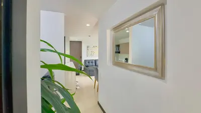 a mirror on a wall in a hallway with a plant at 3BR AC Top Location Views El Poblado in Medellín