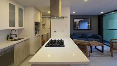 a kitchen and living room with a stove top oven at 2BR Luxe Cozy Views Las Brujas Envigado in Envigado