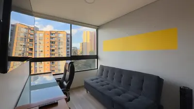 a living room with a couch and a large window at 2BR Luxe Cozy Views Las Brujas Envigado in Envigado