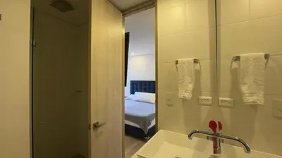 a bathroom with a sink and a mirror and a bed at 2BR Luxe Cozy Views Las Brujas Envigado in Envigado