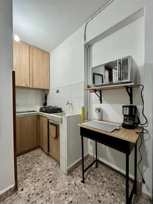 a small kitchen with a table and a counter at Cómodo en zona residencial a 1m de Av. el poblado in Envigado