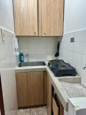 a small kitchen with a sink and a stove at Cómodo en zona residencial a 1m de Av. el poblado in Envigado