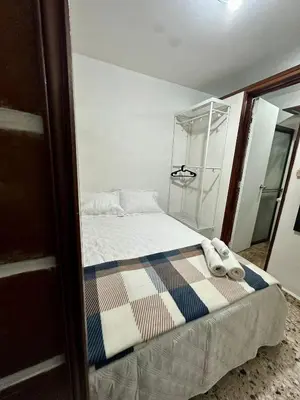 a small bedroom with a bed and a shower at Cómodo en zona residencial a 1m de Av. el poblado in Envigado
