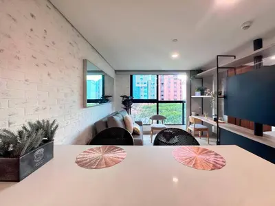 a living room with a table with umbrellas on it at 1BR AC Near Unicentro, UPB & Parques Laureles in Medellín