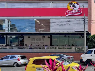 a group of cars parked in front of a restaurant at 1BR AC Near Unicentro, UPB & Parques Laureles in Medellín