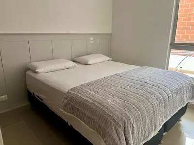 a bed with two pillows on it in a bedroom at Luxury 3BR Apartment in the heart of Medellin in Medellín