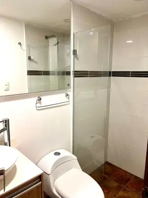 a bathroom with a toilet and a glass shower at Luxury 3BR Apartment in the heart of Medellin in Medellín