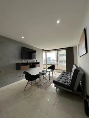 a living room with a couch and a table and chairs at Apartamento en el Poblado junto al cc Santa Fe in Medellín