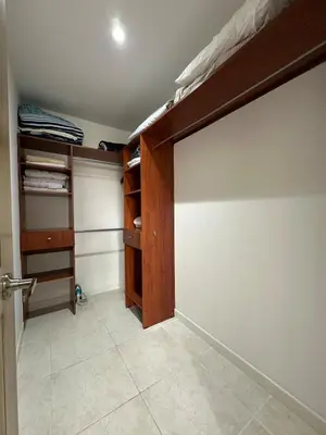 an empty room with a bed and a closet at Apartamento en el Poblado junto al cc Santa Fe in Medellín
