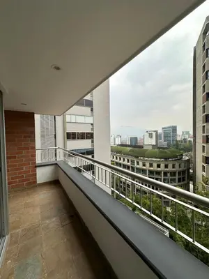 a balcony with a view of the city at Apartamento en el Poblado junto al cc Santa Fe in Medellín