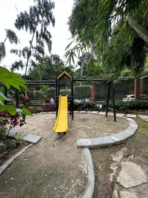 a playground with a yellow slide in a park at Apartamento en el Poblado junto al cc Santa Fe in Medellín