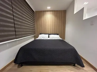 a bedroom with a bed with a black blanket at Lujoso Apartamento a Pasos del Metro de Medellin in Medellín
