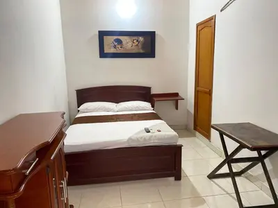 a bedroom with a bed and a desk and a piano at hotel kerana moon in Puerto Boyacá