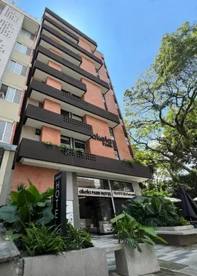a tall building with plants in front of it at Akela Park Hotel in Medellín