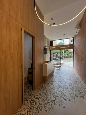 a hallway of a house with a tile floor at Akela Park Hotel in Medellín