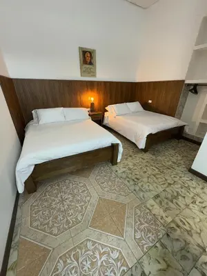 a hotel room with two beds and a carpet at Vivienda turística Casa Rionegro colonial in Rionegro
