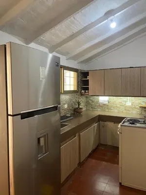 a kitchen with a stainless steel refrigerator in it at Casa Oasis - La Estrella in La Estrella